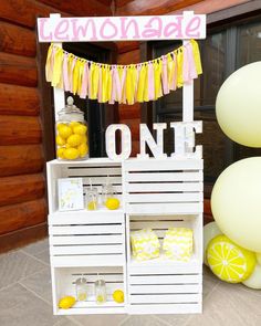 the lemonade stand is decorated with yellow and pink decorations