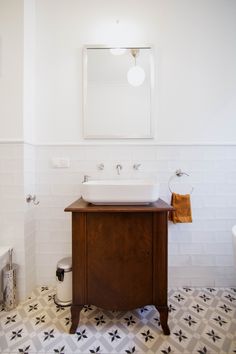 a bathroom with a sink, mirror and toilet