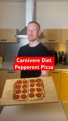 a man is holding up a large pepperoni pizza on a cutting board with the words carnivore diet