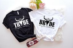 two t - shirts that say tribe and the other one has horns on it