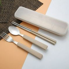 four spoons, two forks and one knife are on the table next to an empty container