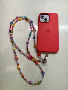 an apple phone case is attached to a lanyard with colorful beads and a keychain