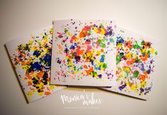 three cards with colorful paint splattered on them