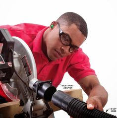 a man using a circular saw to cut wood with a power drill attachment on a table