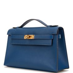 This Mini Kelly Pochette is in Deep Blue swift leather with gold hardware and has tonal stitching, front flap, two straps with center toggle closure and a top flat handle. The interior is lined with Deep Blue chevre and has an open wall pocket. Collection: D Origin: France Condition: - Mint; the bag retains its structure. The leather shows very light signs of use. The hardware is covered with slight scratching to the turn lock. The inside is clean with no wear. Accompanied by: Hermes box, Hermes dustbag, felt, carebook Measurements: 8.5" width x 5" height x 2.5" depth; 1" top handle Luxury Blue Flap Bag With Main Compartment, Luxury Blue Flap Bag For Everyday, Luxury Blue Flap Bag With Magnetic Closure, Luxury Blue Box Bag With Gold-tone Hardware, Hermes Kelly Pochette, Kelly Pochette, Mini Kelly, Open Wall, Ysl Shoes