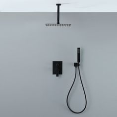 a black shower head and hand held shower faucet in a white bathroom with grey walls