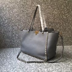 SHOP MORE LUXURY PRODUCTS HERE Description Valentino Medium Grainy Rockstud Bag Gray, For Women, Women’s Bags 19.3in/49cm Size:ÃƒÂ¯Ã‚Â¿Ã‚Â½ÃƒÂ¯Ã‚Â¿Ã‚Â½ÃƒÂ¯Ã‚Â¿Ã‚Â½ÃƒÂ¯Ã‚Â¿Ã‚Â½ 49 x 25 x 14 cm /19.3 x 10 x 5.5 inches (Width x Height x Length) Hook closureRemovable strapFlat zipper pocket Includes dust bag.This product is of the premium quality. Studded Rectangular Bag For Everyday Use, Rectangular Studded Shoulder Bag For Everyday Use, Rectangular Everyday Bags With Studs, Rectangular Studs Bag For Everyday Use, Everyday Use Rectangular Studded Shoulder Bag, Everyday Rectangular Studded Shoulder Bag, Studded Crossbody Bags For Everyday Use, Everyday Crossbody Bags With Studs, Luxury Rectangular Bags With Studs