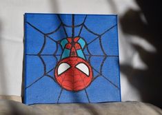 a spider - man painted on the side of a canvas