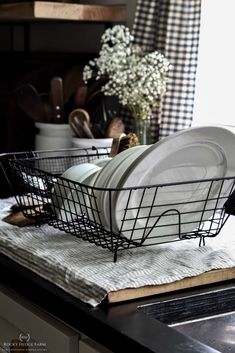 a basket filled with dishes sitting on top of a counter