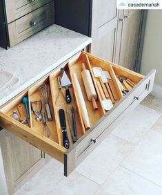 an open drawer in the middle of a kitchen