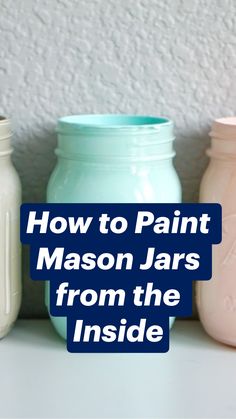 three pastel mason jars lined up against a white wall