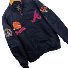 Atlanta Braves Commemorative Bomber Style Jacket Is Absolutely Fire! You Can Be The First To Own This Embroidered Commemorative Jacket Honoring Hank Aaron's 40th And 50th Anniversary Of His Remarkable 715th Home Run, Surpassing The Great Babe Ruth's Long Standing Record! The Bomber Style Jacket Is Made Of High-Quality,Military Grade, Tough Nylon Material And Will Last You A Very Long Time. Reward Yourself With This Gorgeous Special Edition Jacket. Size Xl Form Fit But Not Too Tight High-Grade Ny Blue Long Sleeve Outerwear With Embroidered Graphics, Blue Long Sleeve Outerwear With Embroidered Patch, Blue Outerwear With Embroidered Patch For Fall, Fall Blue Outerwear With Embroidered Patch, Blue Winter Outerwear With Embroidered Patch, Blue Embroidered Winter Outerwear, Hank Aaron, Babe Ruth, Atlanta Braves