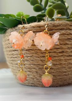 orange Sakura Flower Earrings The orange sakura flower earrings feature three glazed sakura and one plastic floral drop. They are really comfortable for everyday wear.  Available in GOLD and Silver finish! M A T E R I A L S * A N D * S I Z E  The hook is 14K gold filled - Length: 50mm(without the hook) - Width: 23mm Whimsical Dangle Flower Earrings, Whimsical Dangle Jewelry With Flower Charm, Unique Orange Flower Shaped Jewelry, Unique Orange Flower-shaped Jewelry, Rose Gold Flower Jewelry For Summer, Summer Rose Gold Flower Jewelry, Elegant Orange Jewelry For Spring, Elegant Orange Spring Jewelry, Bohemian Dangle Earrings With Flower Charm