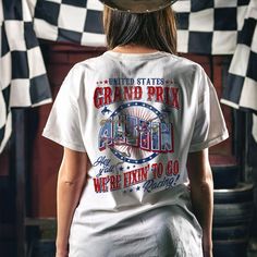 a woman wearing a t - shirt that says grand prix and we're going to go