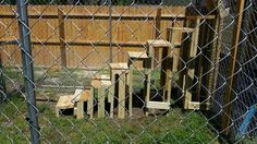 a fenced in area with several wooden steps