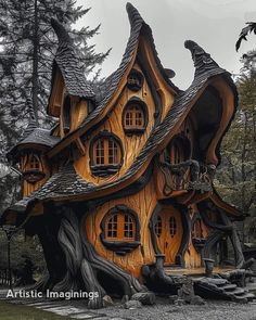 a house made out of wood with windows and trees in the front yard, surrounded by rocks