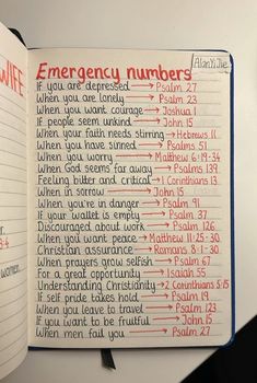 an open notebook with emergency numbers on it