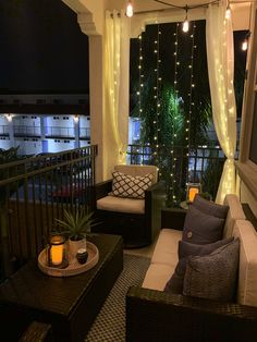 a living room filled with furniture and lights on the windows sill, next to a balcony