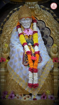 the statue is decorated with flowers and garlands