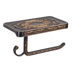 a black and gold table with a metal hook on it's end, in the shape of a dragon