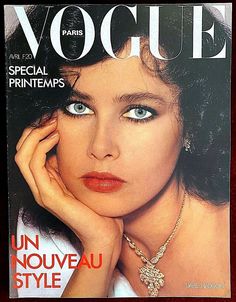 a magazine cover with an image of a woman wearing jewelry on her neck and hands near her face