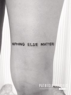 a woman's lower leg with the words nothing else matters written on her side