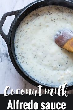 a close up of food in a pot with a wooden spoon on the side and text overlay that reads coconut milk alfredo sauce