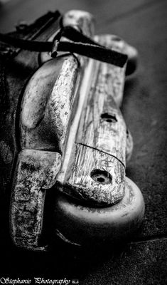 an old wooden object is laying on the ground