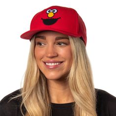 This Sesame Street hat is the ultimate accessory for the young or the young at heart. This bright red hat features a high-quality embroidered Elmo face on the crown, with a pre-curved brim and an adjustable snapback, ensuring a perfect fit for heads of all sizes. The sturdy yet lightweight construction makes it ideal for daily wear, outdoor adventures, or showcasing your Elmo admiration at themed events and parties. This snapback hat is a unique collector's item for Sesame Street enthusiasts. Adjustable Flat Bill Red Hat, Red Adjustable Flat Bill Hat, Novelty Baseball Cap With Flat Bill And Adjustable Fit, Red Adjustable Hat With Embroidered Logo, Novelty Adjustable Flat Bill Baseball Cap, Fun Red Snapback Trucker Hat, Fun Red Snapback Hat With Curved Brim, Red Snapback Hat, One Size Fits Most, Fun Red Curved Brim Snapback Hat