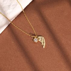 Remember your loved ones with our Angel Wing Birthstone Necklace. This personalized jewelry piece not only adds a touch of sentimental value, but also serves as a thoughtful gift for mothers, especially for Mothers Day. Keep your loved ones close to your heart with this special necklace. Fine Jewelry Tarnish Resistant Charm Necklace As Gift, Diamond Charm Necklace As Gift, Diamond Charm Necklace For Gift, Diamond Charm Necklace With Round Pendant For Gift, Personalized White Gold Jewelry For Memorial, Dainty Diamond Charm Necklaces As Gift, Diamond Gemstone Charm Necklace For Gift, Diamond Pendant Birthstone Necklace Gift, Diamond Charm Necklaces As Gift