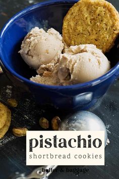 two scoops of pistachio ice cream in a blue bowl next to cookies