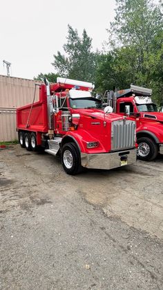 two large red trucks parked next to each other