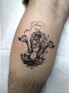 a man's leg with a tattoo on it that has an image of a monkey sitting in the water