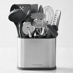 a metal container filled with kitchen utensils