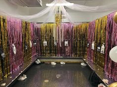 the room is decorated with gold and pink streamers