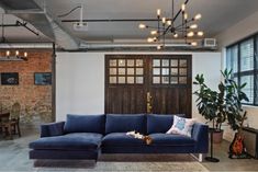 a blue couch sitting in front of a wooden door