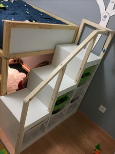 there is a bunk bed with shelves underneath it