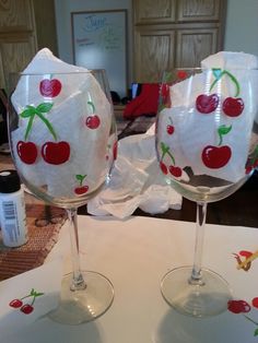 two wine glasses with cherries painted on them