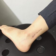 a woman's foot with the word love tattooed on her left leg and an inscription written in cursive writing