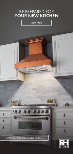 a kitchen with white cabinets and an orange range hood