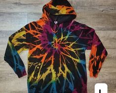 a tie - dyed hoodie is shown on the floor