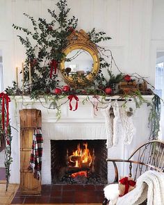 a fireplace decorated with greenery and stockings