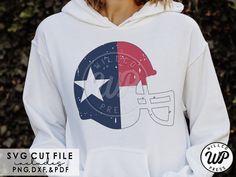 a woman wearing a white hoodie with the american flag on it and a football helmet