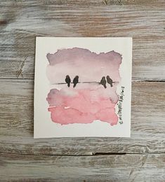 two birds are sitting on a wire with pink watercolor