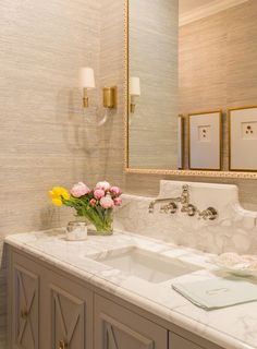 a bathroom with two sinks and a large mirror above it's counter top,