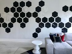 a modern living room with black and white hexagonal wallpaper on the walls