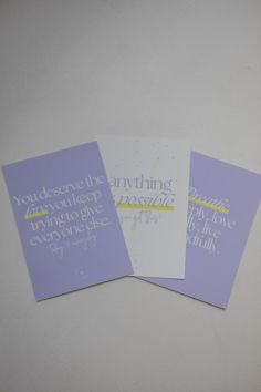 three purple cards with white writing on them