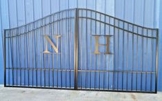 an old iron gate with the letter h on it and two letters that are in gold