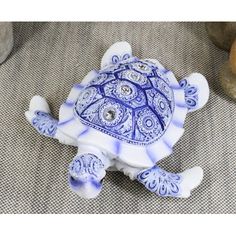 a blue and white turtle figurine sitting on the ground