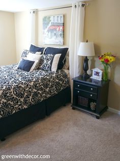 a bedroom with a black and white comforter on the bed